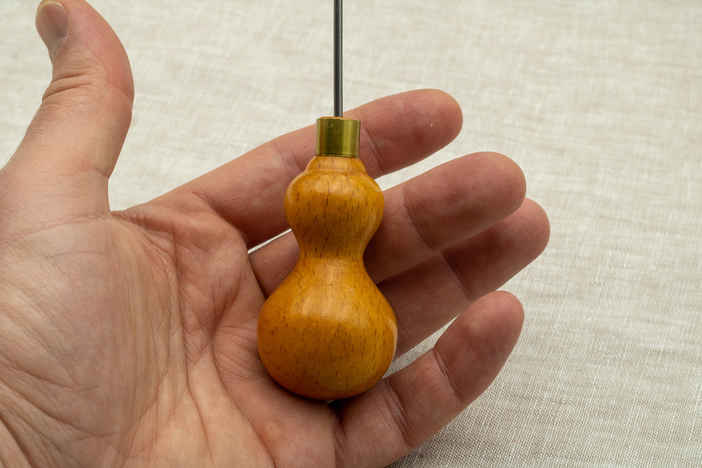 Clicker's awl in hand palm of leatherworker